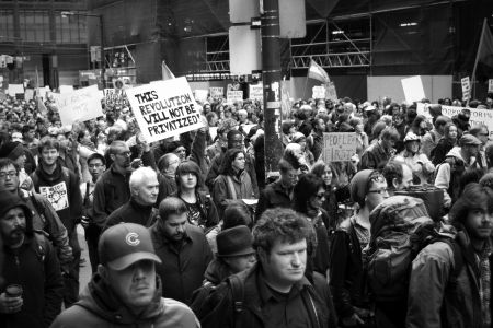 Thousands march in the streets of Toronto's financial district.