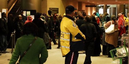 Police look on as demonstrators chant "We won't be quiet 'til we get our Special Diet"