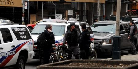 Police declined to comment on how they weigh deploying the Emergency Task Force against refugees with experience of violence. In the background, a new luxury condo development.