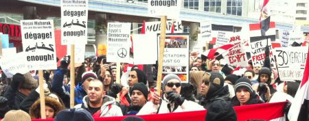 Demonstraters held homemade signs in many languages. (photo credit: Paul Kellogg)