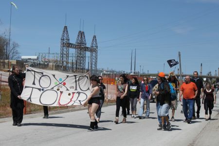 Toxic Tour participants walk past Suncor