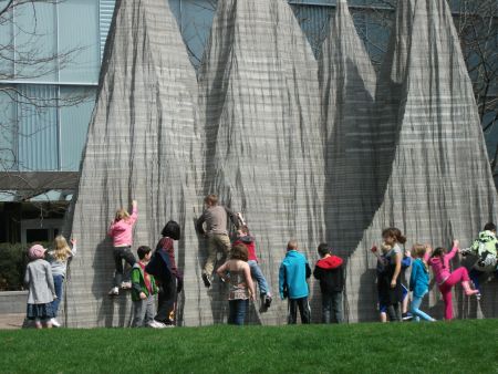 In the park across the street from the Barrick AGM, children climbed a statue of mountains reminding that human creativity can overcome both corporate art and corporate impunity. (photo: Graeme Bacque)