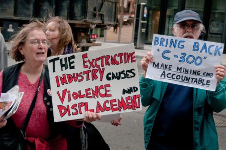 Some activists held signs protesing the failure of Bill C300, which would have allowed the Canadian goverment to investigate allegations of human rights abuses without the permission of the mining company. Despite being put forward by Liberal backbencher John McKay, the Bill was defeated after its 3rd reading due to weak support from Liberal party leaders. (photo: Allan Lissner)