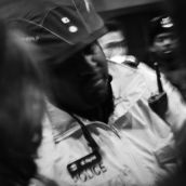 A Toronto police officer argues with protesters.