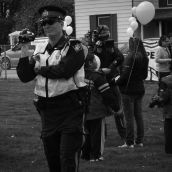 An OPP officer uses a video camera to document who is present at the rally. Note: nothing criminal had taken place or was in the process of taking place.