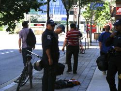 Photographer being questioned and searched by police 