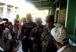 Nov. 29, 2009 - The polling station has more soldiers than civilians, and those civilians who are around are patently aware of the military presence.  Representatives of human rights group FIAN and a reporter from Radio Globo confront the military about their overwhelming show of force in what is supposed to be a free and open process.  Things get tense and the FIAN representatives decide that it is best to leave - many of them have been targeted with beatings and death threats already.