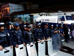 Nov. 30, 2009 - As the sun sets, the caravan arrives at the Brazilian embassy where the demonstration builds slowly as each car or truck full of people arrive.  They are met with a sight they are, by now, used to: a row of police in riot gear with tear gas and water cannons and automatic weapons.