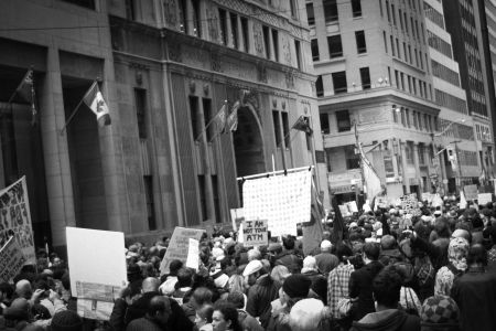 Thousands march in the streets of Toronto's financial district.