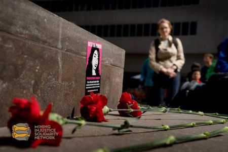 The crowd left flowers and candles on Goldcorp's front steps in commemoration of Topacio Reynoso Pacheco. This 16 year old mining resistance activist was murdered a year ago for her resistance to the Escobal mining project, jointly owned by Goldcorp and Tahoe Resources.