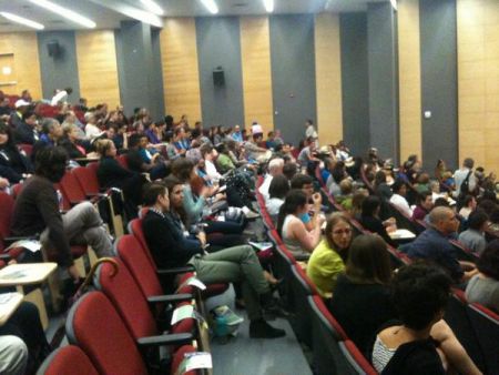 An early shot of the crowd gathering at the Rogers School of Management auditorium