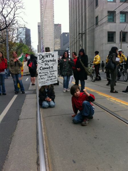 Two young protesters show their solidarity.  Photo by Krystalline from Rabble.