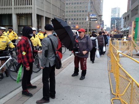 Protesters block Frank Delango from documenting