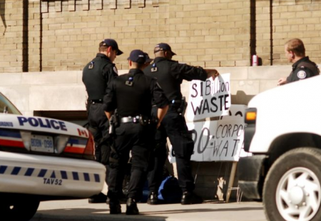 Cops question man with signs // Andrew Mindszenthy