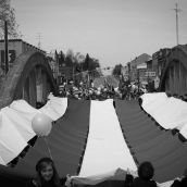 A giant Guswhenta (Two-Row Wampum) is carried across the Argyle Street Bridge over the Grand River. 