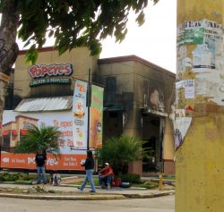 Nov. 26, 2009 - Months earlier, a peaceful demonstration of hundreds of thousands of people was interrupted by individuals who were later identified as infiltrators.  The provocatuers provoked a violent action against a Popeye's Chicken store and a few hundred people joined in - the fast food chains in Tegucigalpa are understandably resented for the fact that they are exempt from all taxes.  No one was hurt when the empty store was firebombed but the event justified major repression the next day